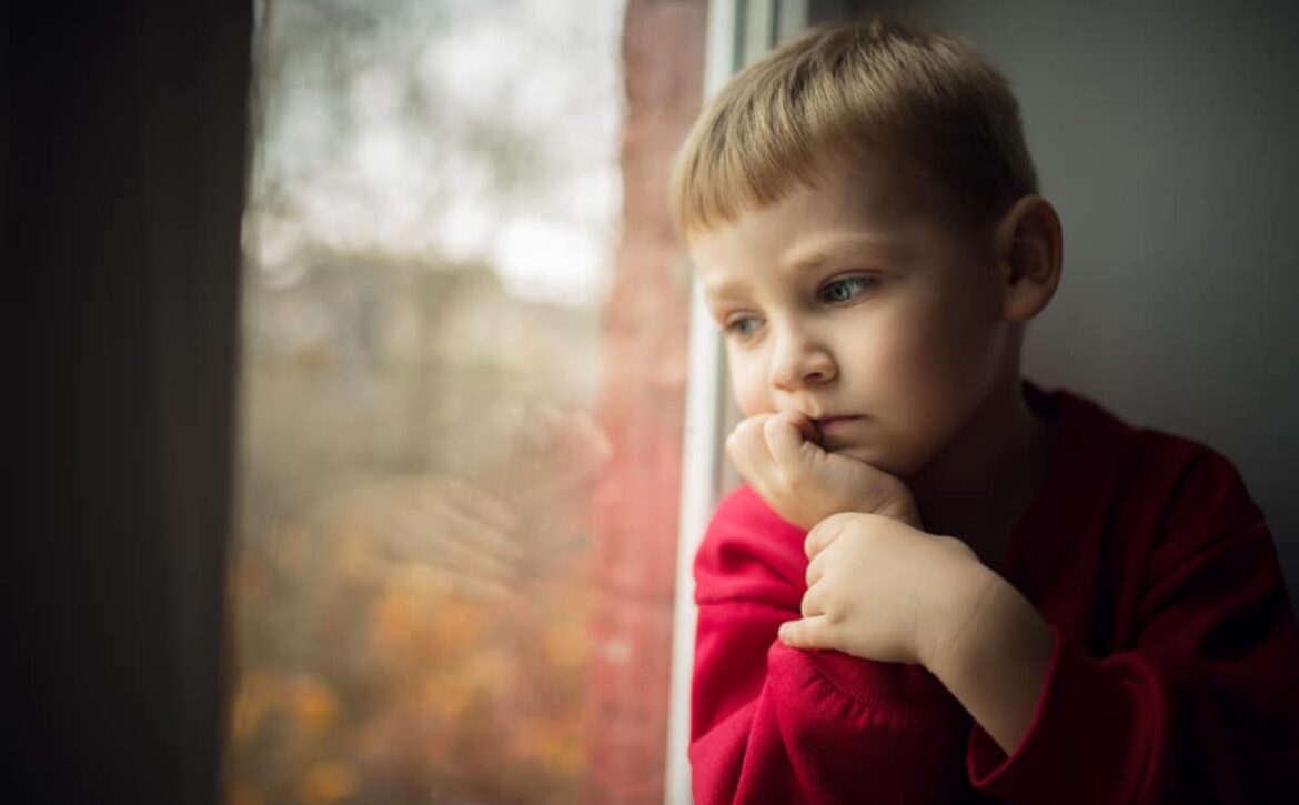 Small,Boy,Sitting,Near,Window,And,Thinking,About,Something