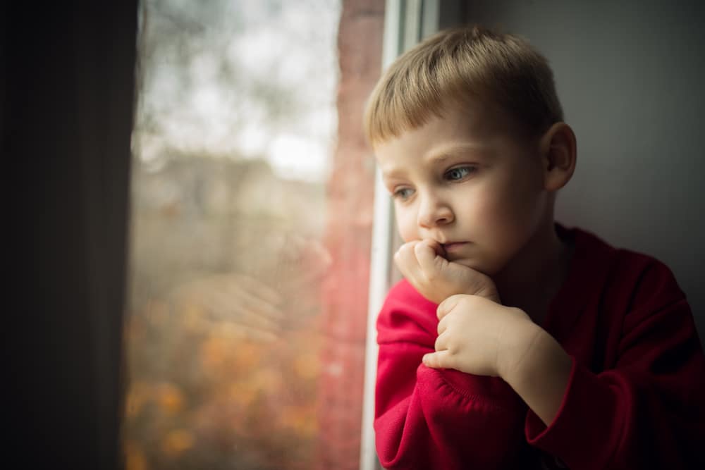 Small,Boy,Sitting,Near,Window,And,Thinking,About,Something