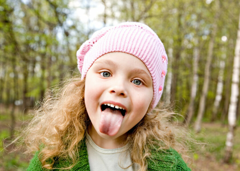 Cheerful,Little,Girl,In,A,Pink,Cap,Puts,Out,The