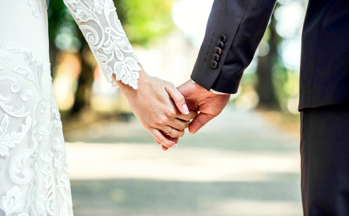 Closeup,View,Of,Married,Couple,Holding,Hands